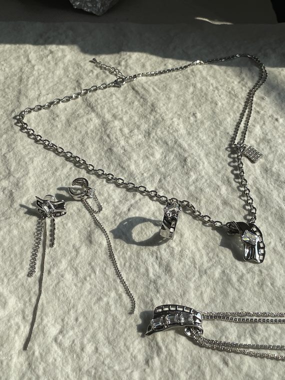 Courtside 09 / Jewelry and shadows on fabric