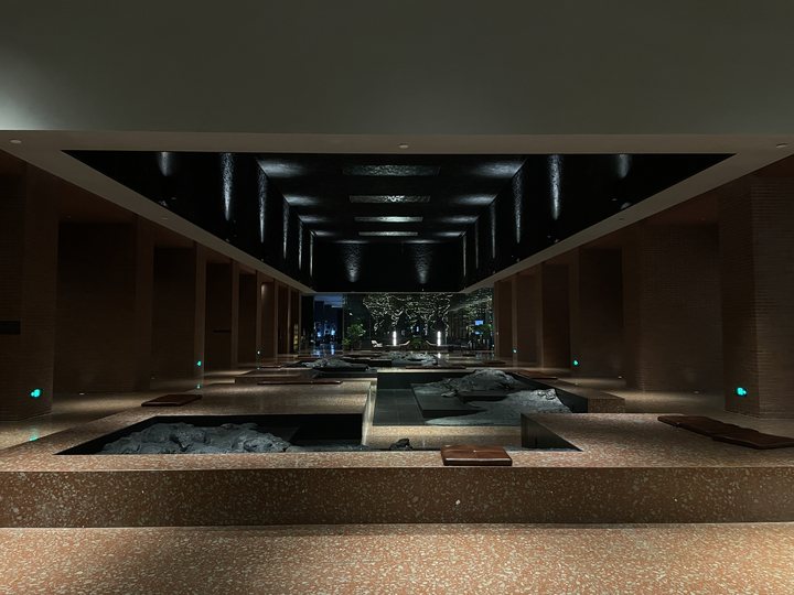 Foreign Body 16 / Symmetrical hotel corridor and pool at night